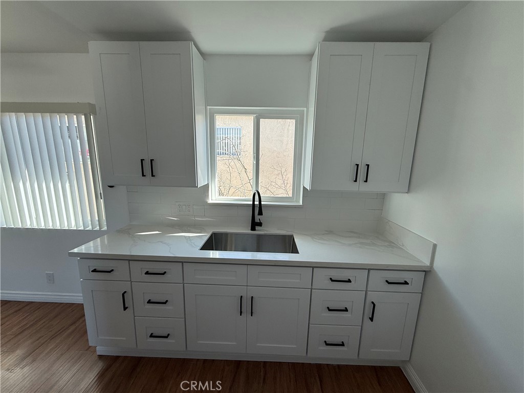 7159 Greeley Street, Unit F Tujunga, CA 91042 - Photo 2 of 15 a kitchen with white cabinets a sink and dishwasher