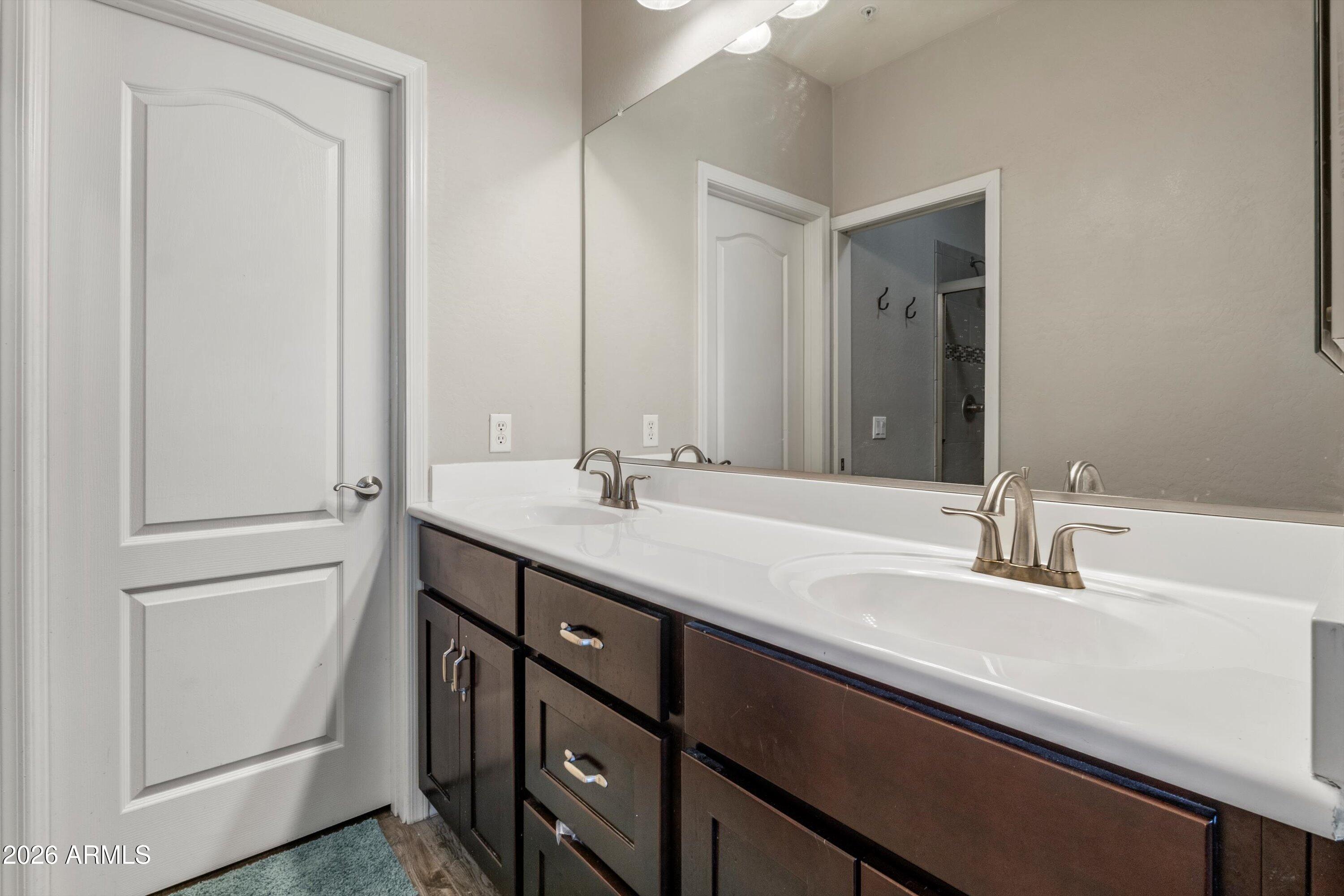 7726 East Baseline Road, Unit 247 Mesa, AZ 85209 - Photo 17 of 29 a bathroom with a double vanity sink and mirror
