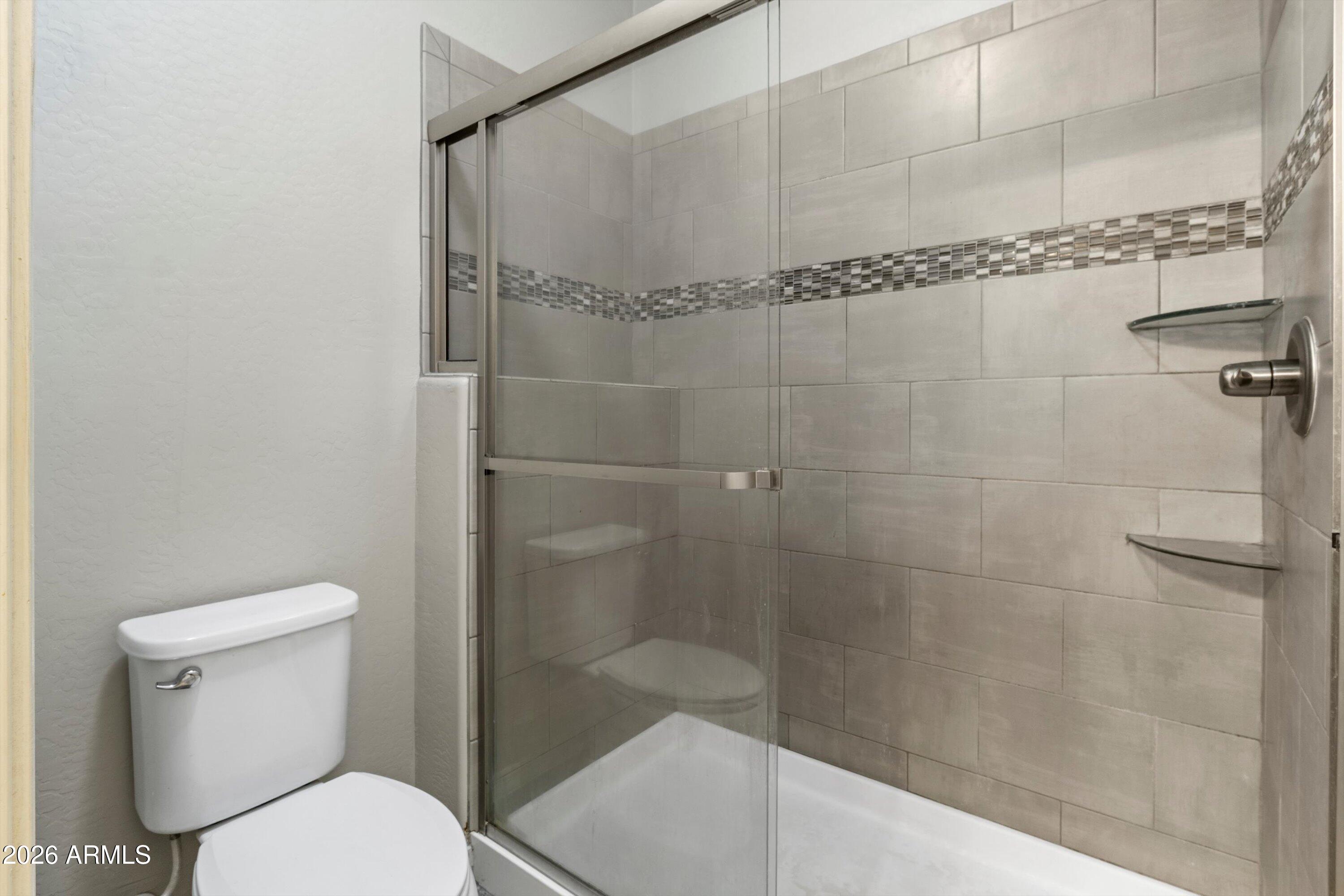 7726 East Baseline Road, Unit 247 Mesa, AZ 85209 - Photo 18 of 29 a bathroom with a shower and toilet