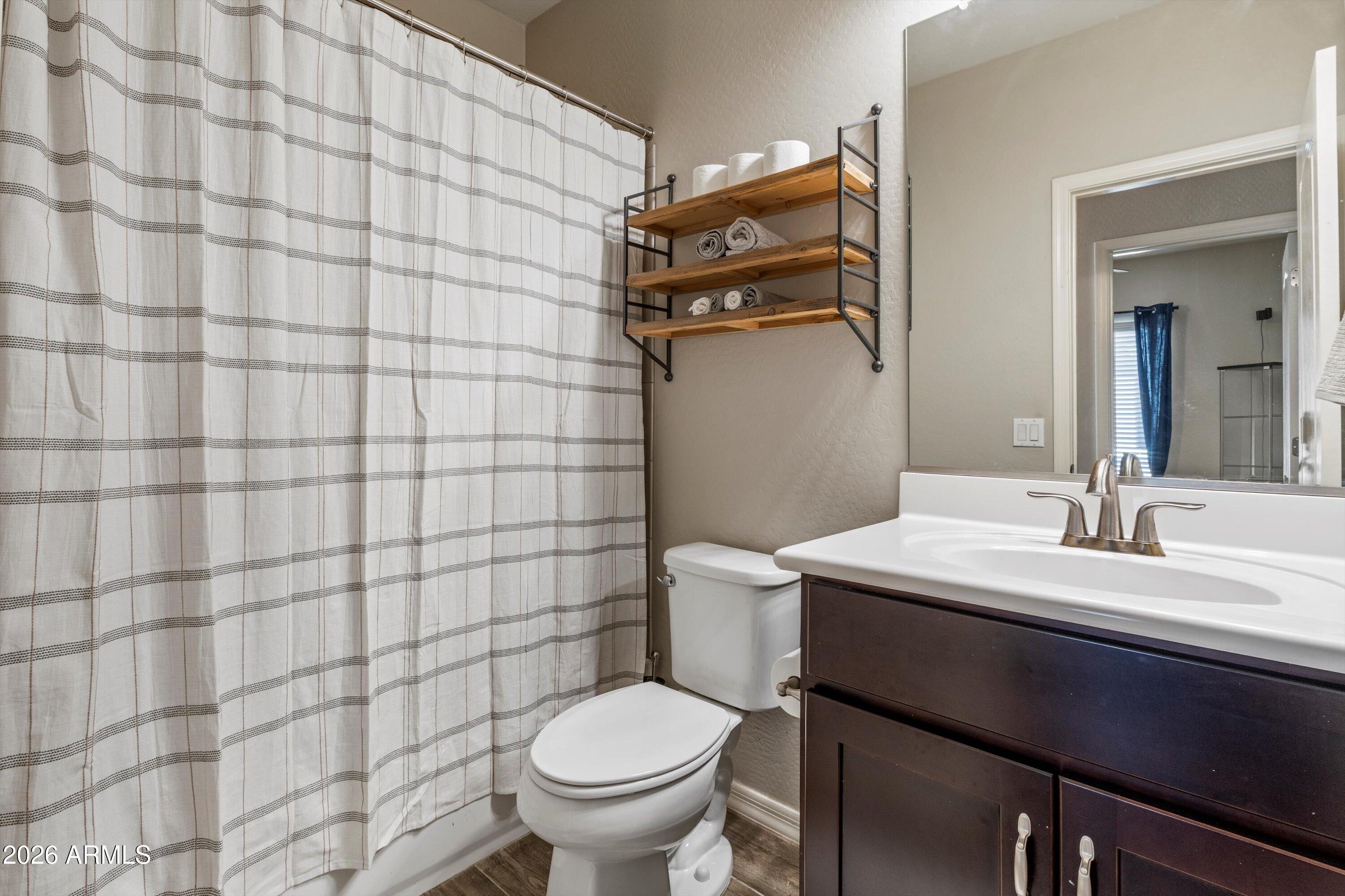 7726 East Baseline Road, Unit 247 Mesa, AZ 85209 - Photo 21 of 29 a bathroom with a sink toilet and shower