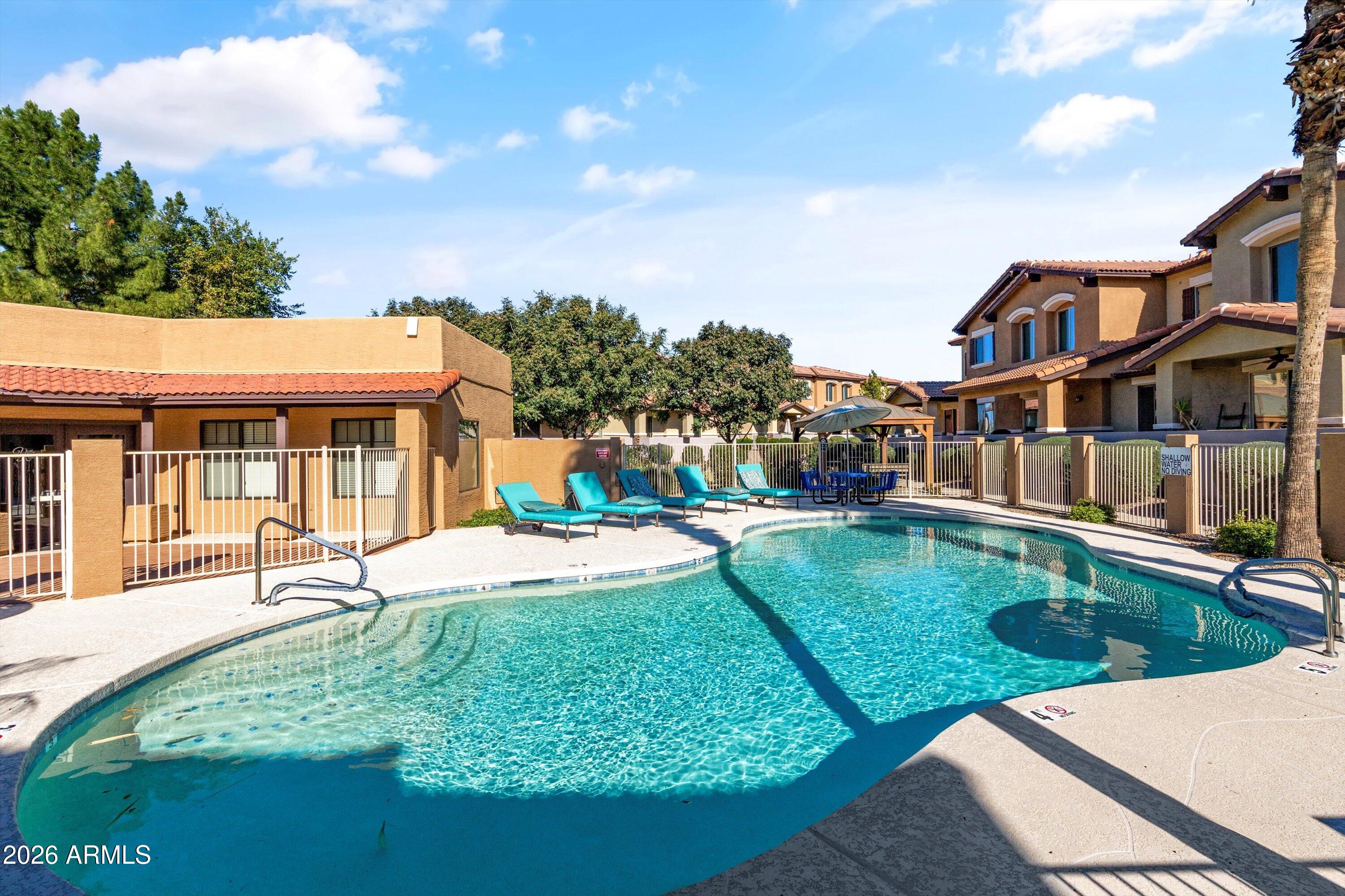 7726 East Baseline Road, Unit 247 Mesa, AZ 85209 - Photo 23 of 29 a view of a house with swimming pool and sitting area