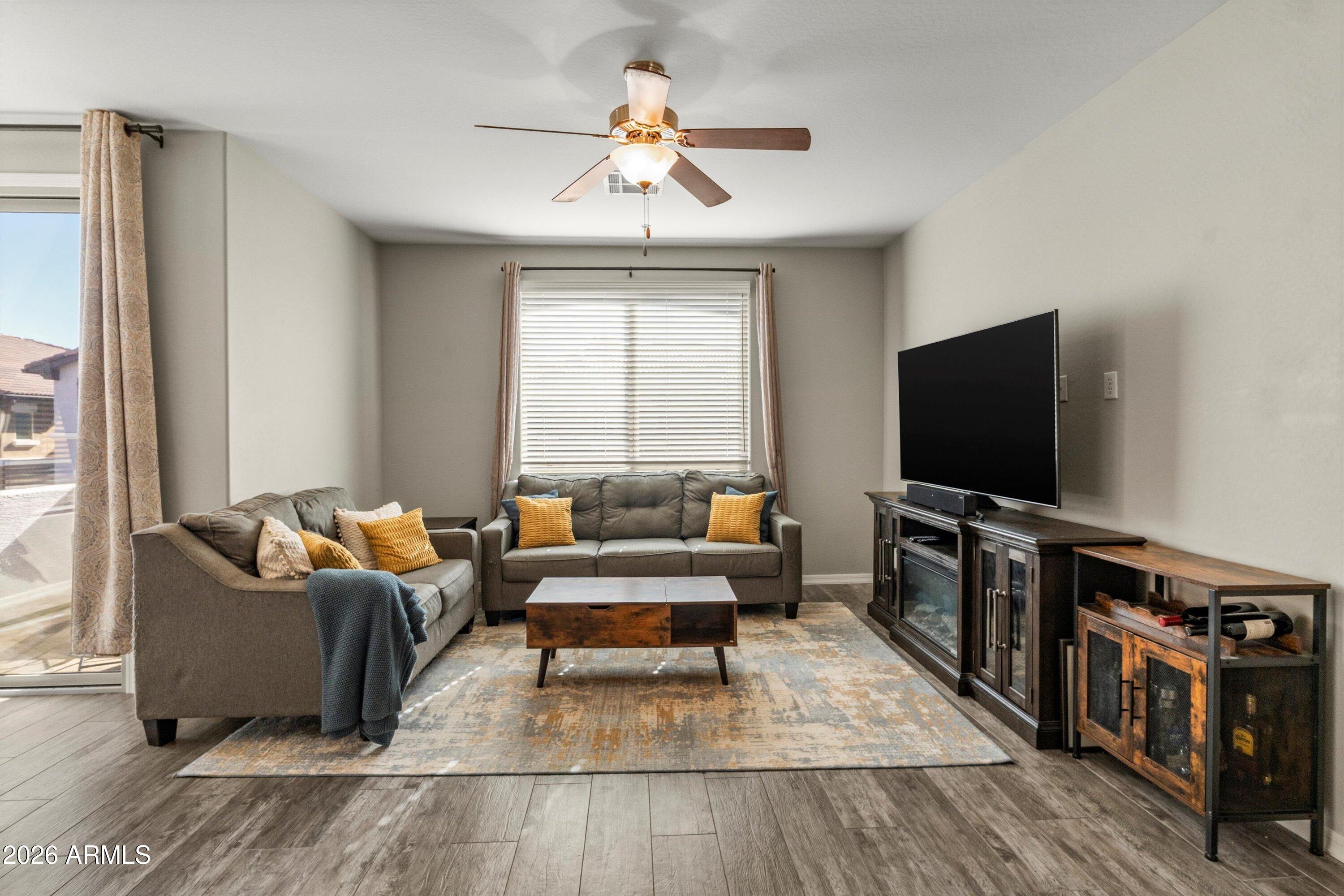 7726 East Baseline Road, Unit 247 Mesa, AZ 85209 - Photo 9 of 29 a living room with furniture and a flat screen tv