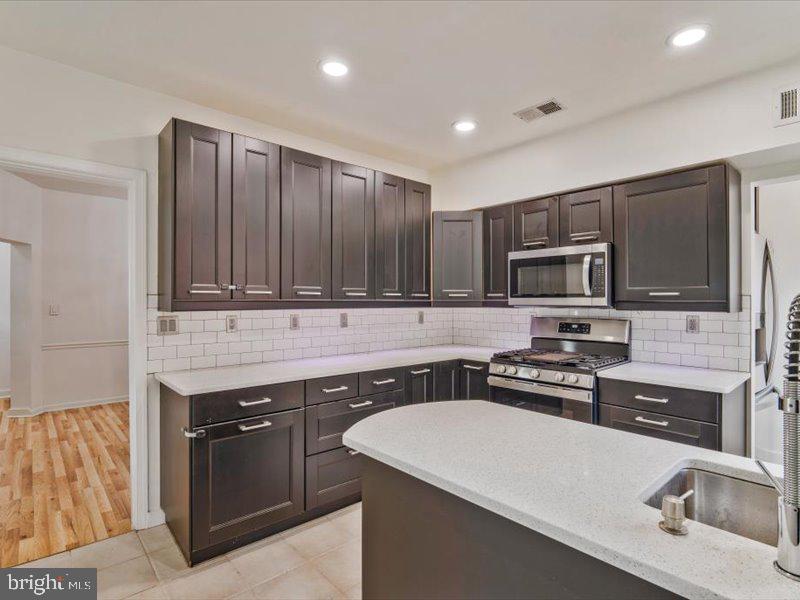 1200 D Street Northeast Washington, DC 20002 - Photo 9 of 47 Sleek modern kitchen with elegant finishes.