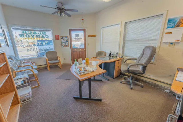 a living room with furniture and a book shelf
