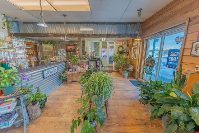 a view of a porch with dining table and chairs potted plants