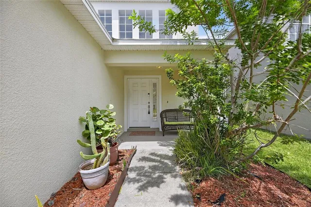 a view of a backyard with chair and the garden