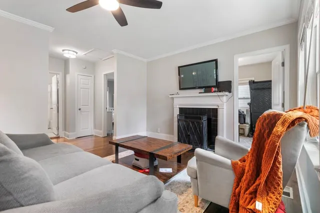 a living room with furniture and a fireplace