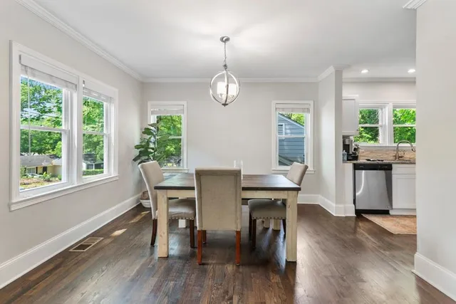 a view of a dining room with furniture window and wooden floor