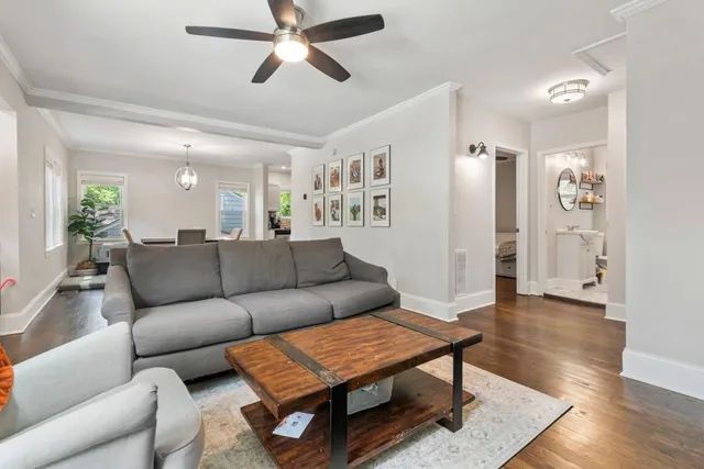 a living room with furniture and wooden floor