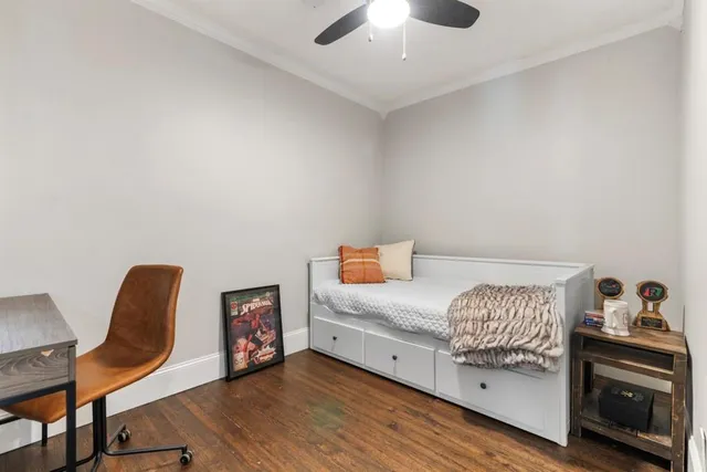 a bedroom with a bed and a chair