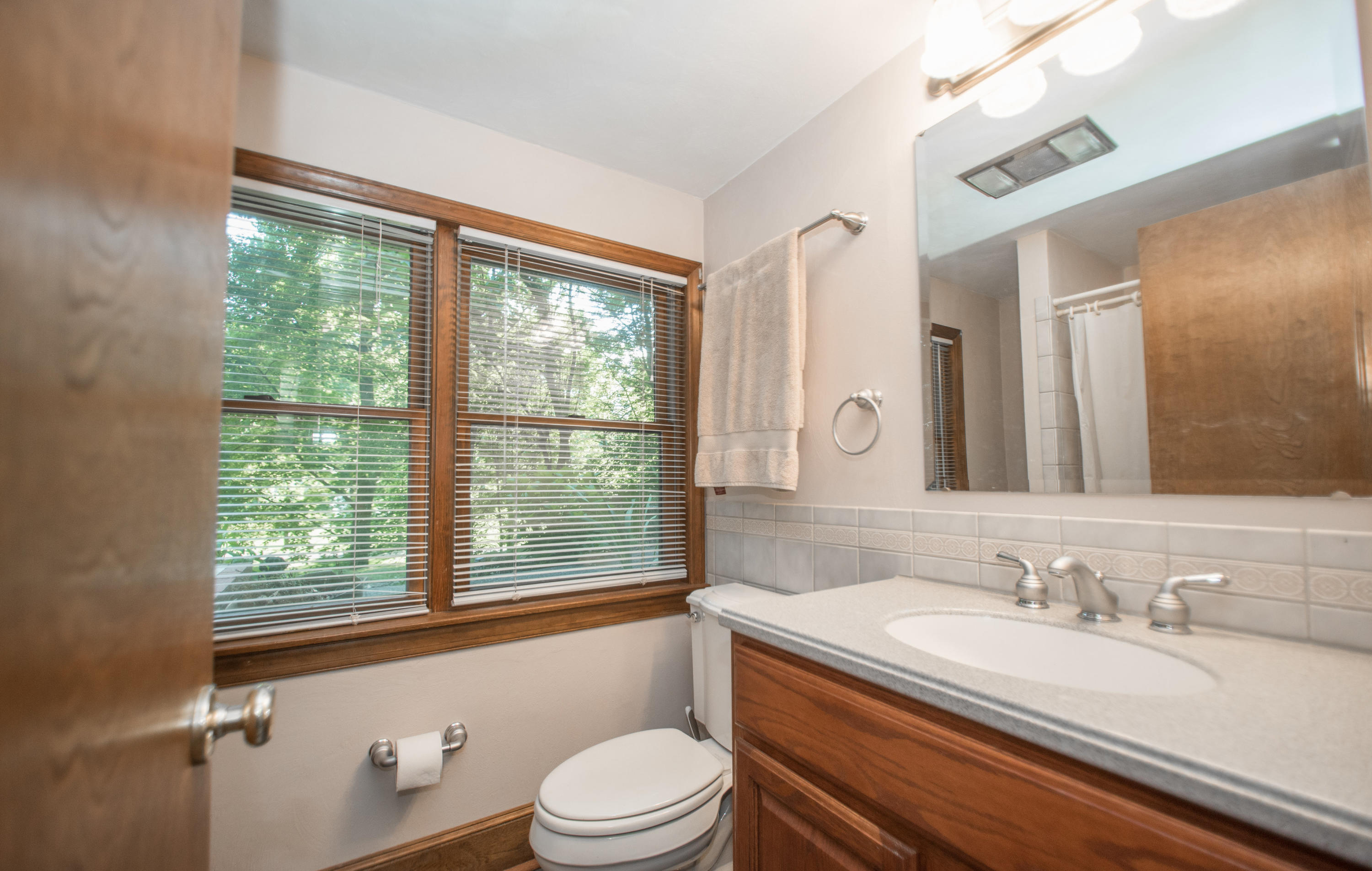 2524 Blue Ridge Springs Road Blue Ridge, VA 24064 - Photo 22 of 44 a bathroom with a granite countertop sink toilet a mirror and a tub