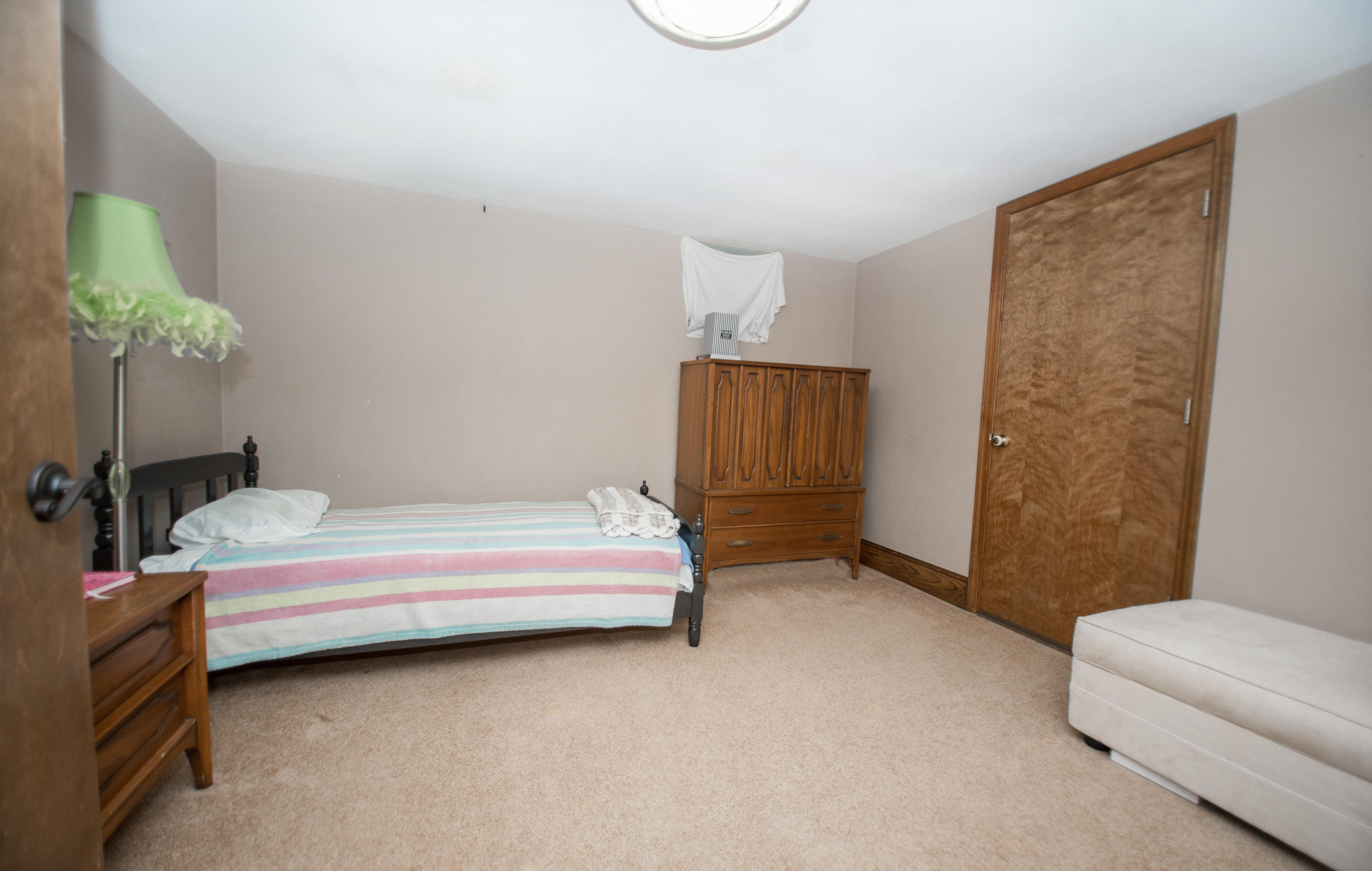 2524 Blue Ridge Springs Road Blue Ridge, VA 24064 - Photo 28 of 44 a bedroom with a bed and a chair