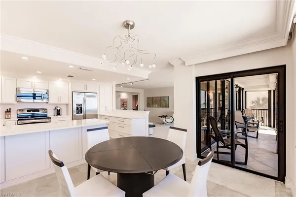 a kitchen with stainless steel appliances kitchen island granite countertop a sink and cabinets