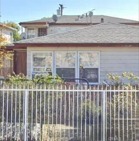 a front view of a house with a fence