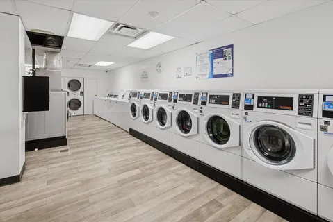 a utility room with dryer washer and a refrigerator