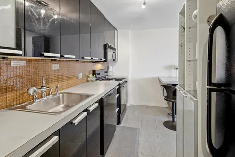 a room with a sink a washer and dryer