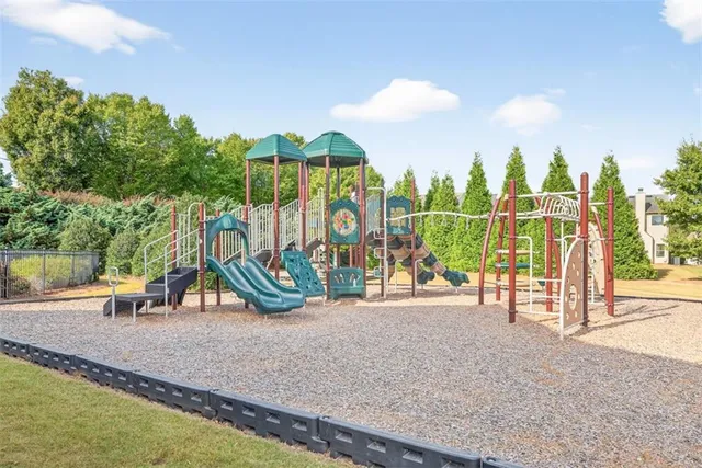 a view of a park with swings and slides
