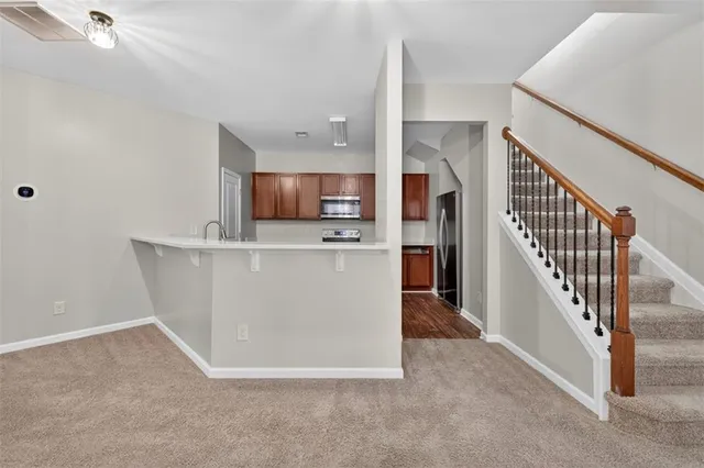 a view of a kitchen with furniture and an empty room