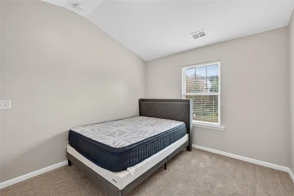a bed sitting in a room next to a window