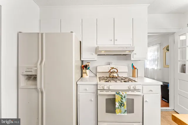 a kitchen with a refrigerator and a stove