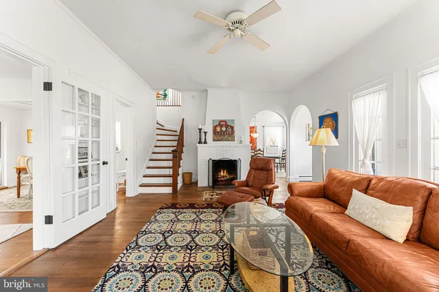 a living room with furniture a fireplace and a large window