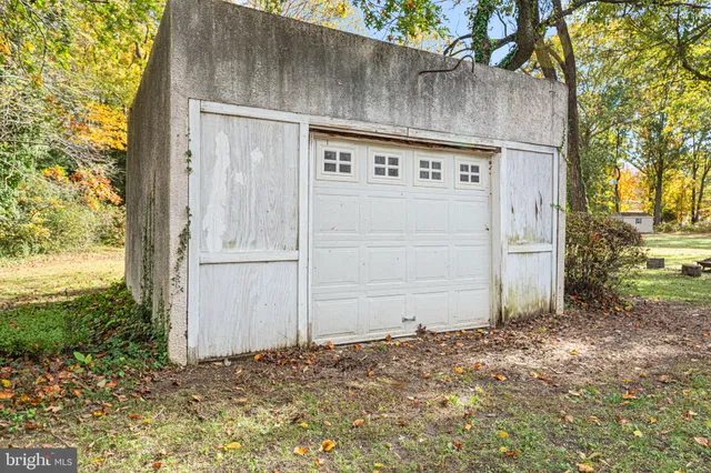 a view of a house with a large tree and a yard