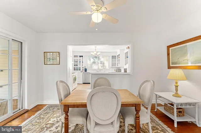 a view of a a dining room with furniture window and wooden floor