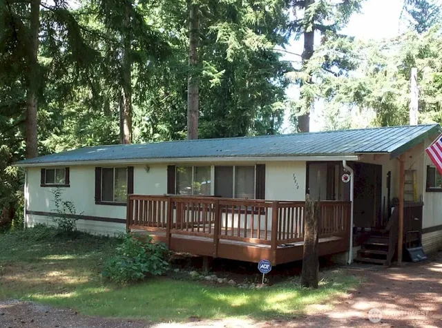 a view of a house with a yard and deck