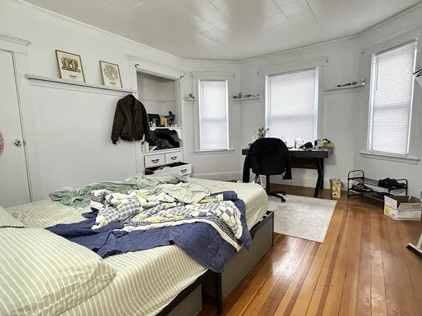 a bedroom with furniture and a large window