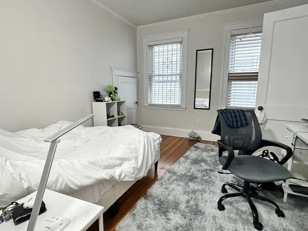 a bedroom with a bed and a chair
