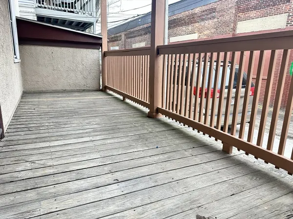 a view of balcony with wooden floor