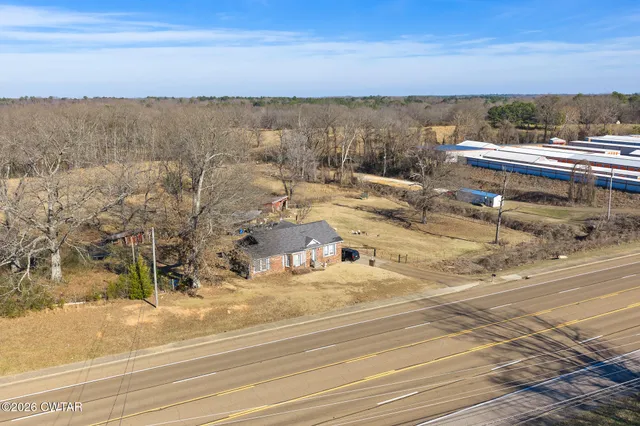 a kitchen that has a lot of cabinets in it and a window