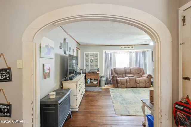 a bathroom with a granite countertop sink toilet a mirror and a window