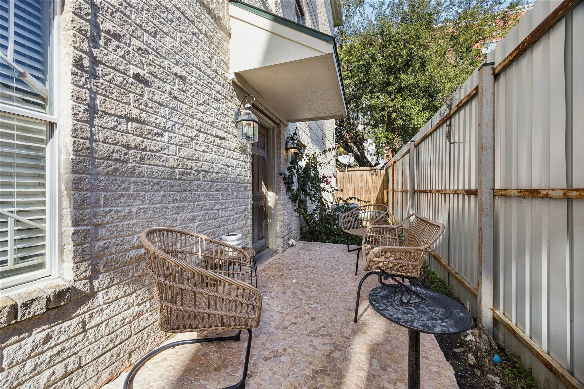 2207 Austin Street Houston, TX 77002 - Photo 27 of 34 And a view towards the other side of the yard. Beyond the plant are 2 A/C condensors. One is for the 2st floor, and the other is for the 2nd, 3rd and 4th floors. The second A/C was replaced in 2024.