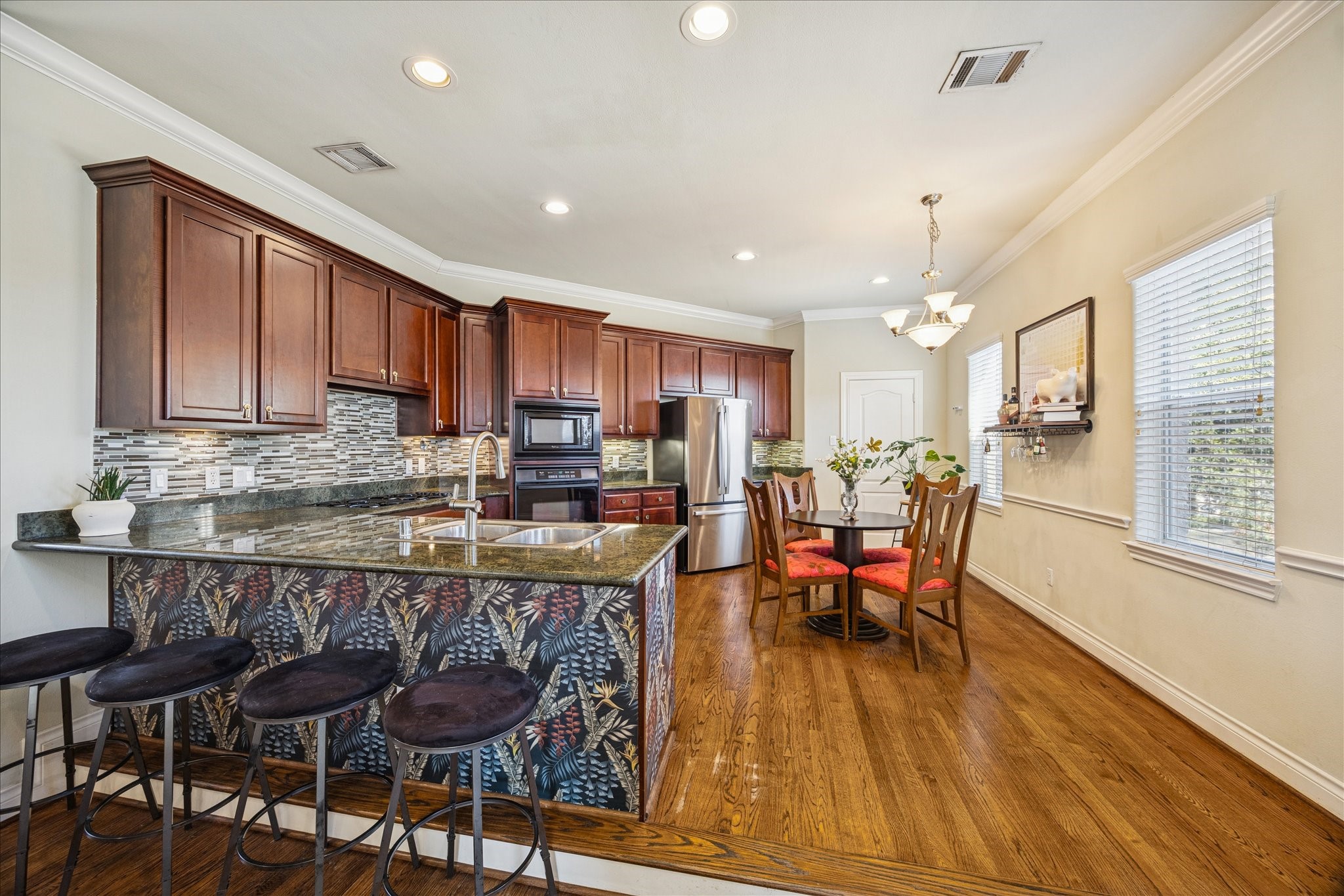 2207 Austin Street Houston, TX 77002 - Photo 5 of 34 This is the gorgeous kitchen that is open to the living room. Granite countertops, gorgeous and plentiful cabinets and drawer space. Breakfast bar, gas cooktop, microwave, electric oven and stainless steel refrigerator (2 years old) that will stay. The door straight ahead and to the right is the huge walk-in pantry. More windows!