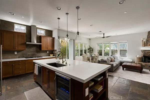 a kitchen that has a sink a counter top stainless steel appliances and cabinets