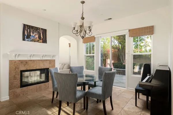 a dining room with furniture window fireplace and wooden floor