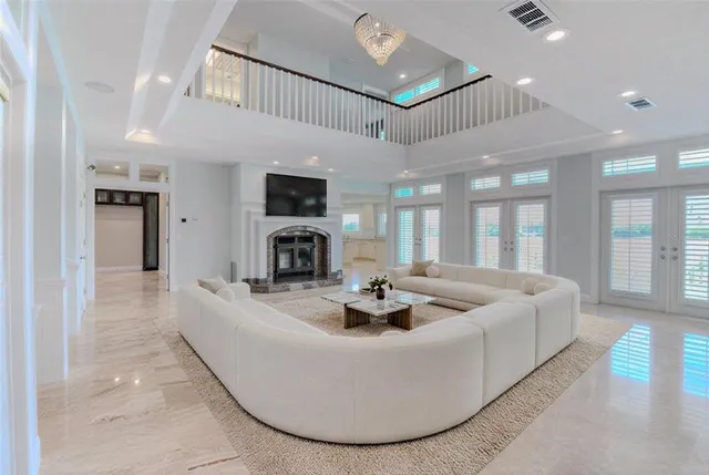 a living room with furniture potted plant and a large window