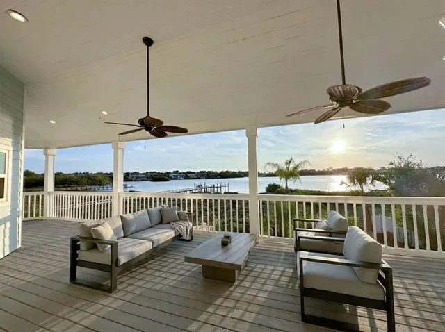 a view of a house with swimming pool and sitting area