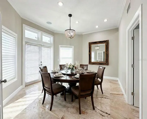 a kitchen with stainless steel appliances a stove a refrigerator a sink and a window