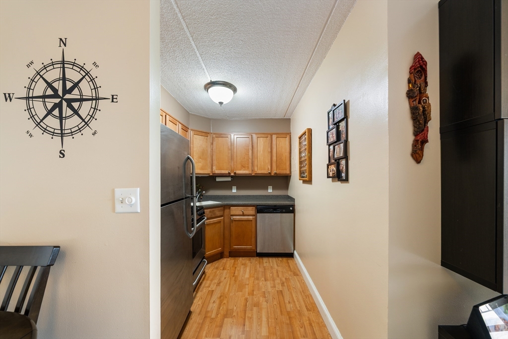 1500 Worcester Road, Unit 624 Framingham, MA 01702 - Photo 14 of 26 a kitchen with stainless steel appliances granite countertop a refrigerator and a stove top oven
