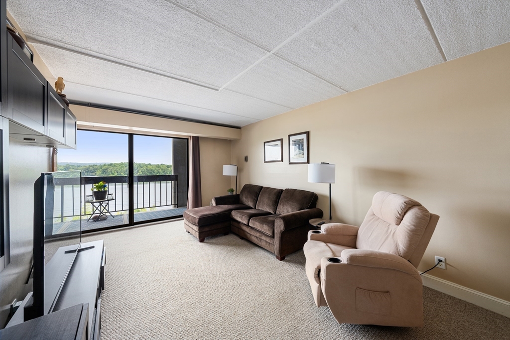 1500 Worcester Road, Unit 624 Framingham, MA 01702 - Photo 7 of 26 a living room with furniture and a large window