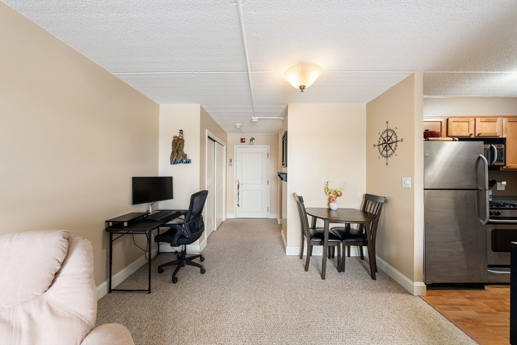 1500 Worcester Road, Unit 624 Framingham, MA 01702 - Photo 10 of 26 a workspace with furniture and a chandelier