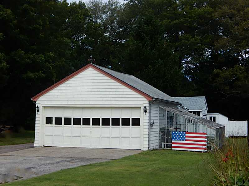 111 Curran Road Cumberland, RI 02864 - Photo 2 of 22 Exterior Front. 2 Car Garage with lg workshop and greenhouse