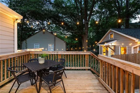 a view of house with a deck and furniture