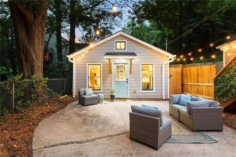 a front view of house with outdoor seating and yard
