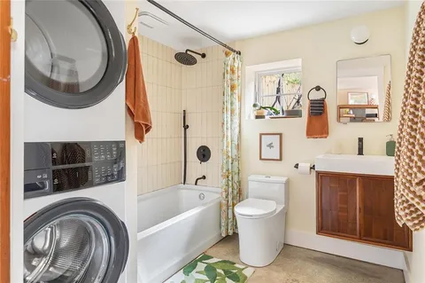 a bathroom with a toilet a sink and mirror
