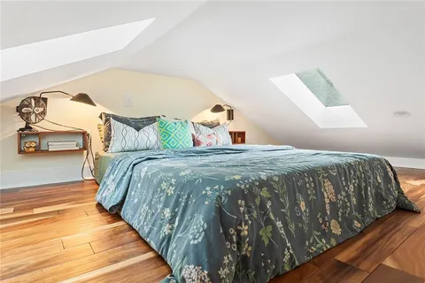 a bedroom with a bed and a mirror