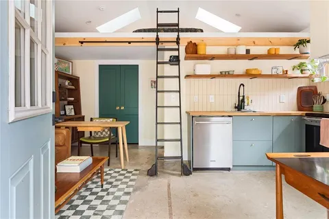a balcony with table and chairs