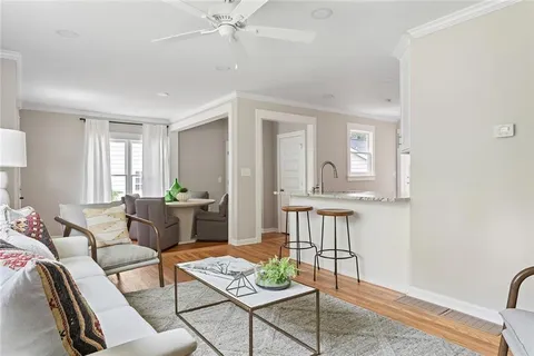 a living room with furniture and wooden floor